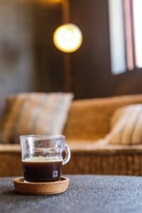 Clear Glass Mug With Brown Liquid on Brown Wooden Table